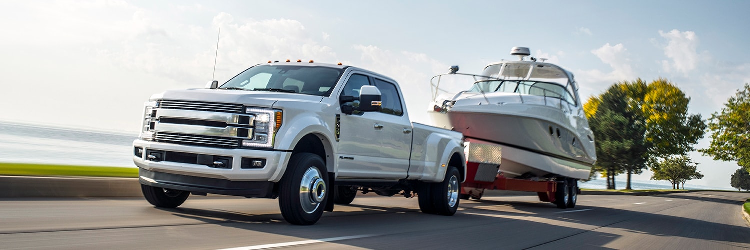 A diesel truck towing a large boat